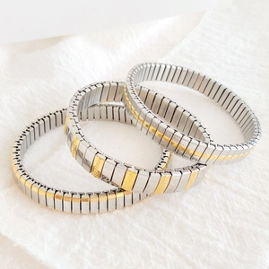 Close-up of modular stretch bracelets in silver and gold tone stainless steel finish