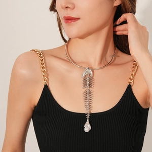 Detail shot of a silver fishbone pendant necklace featuring a white irregular pearl drop