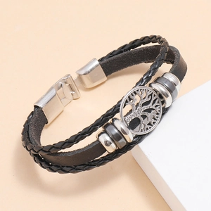 Men's braided leather bracelet with silver tree of life charm on geometric background