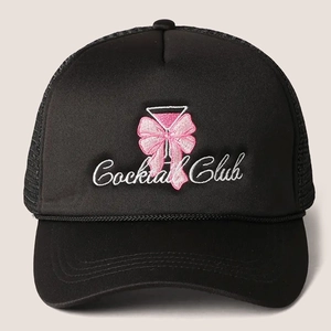 Detail of Cocktail Club embroidery with pink bow on black trucker mesh cap front