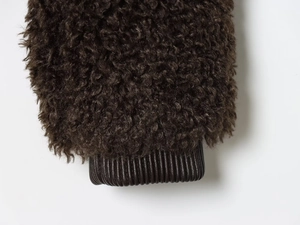 Detailed view of dark brown fleece sleeve featuring ribbed cuffs on this jacket
