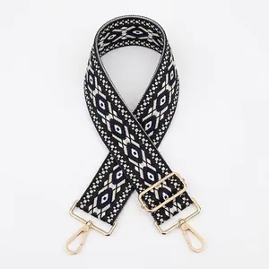 Close-up of geometric diamond pattern strap with golden metal lobster clasps