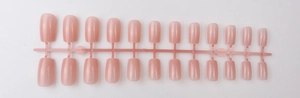 Flat lay of 24 pieces long square nude pink press-on nails with shiny UV top coat finish