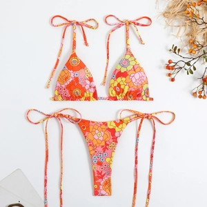 Flat lay of retro floral print bikini set with adjustable halter and side tie details
