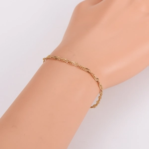 Elegant gold twisted rope chain bracelet displayed on a model wrist for a stylish look