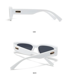 Detail view of retro narrow white frame sunglasses with gold and black side ornaments