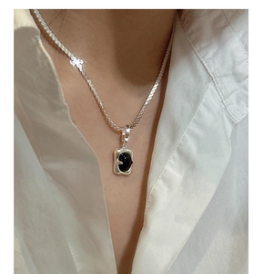 Detail of S925 silver snake chain necklace with a black onyx rectangular pendant