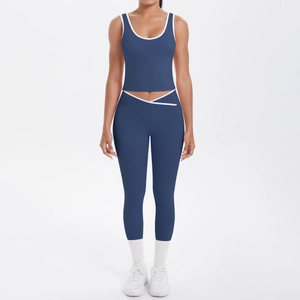Navy blue two-piece yoga set with contrast white trim and high-waisted cross leggings