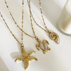 Gold stainless steel ocean necklace set featuring starfish turtle and conch shell pendants