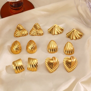 Golden geometric earrings set with wave textures on elegant satin fabric