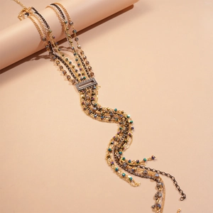 Detail of multi-layered tassel necklace with rhinestone rectangle buckle and beads