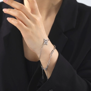 Fashionable stainless steel layered bracelet set with geometric pendant on wrist