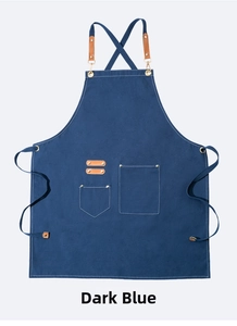 Detail of navy blue canvas apron featuring leather straps and metal reinforcement rivets