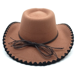 Detailed close-up of brown wool felt cowboy hat with black stitched edges and leather cord