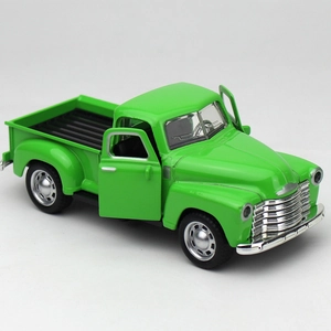 Macro detail of a vintage green alloy pickup model with open doors and chrome grille