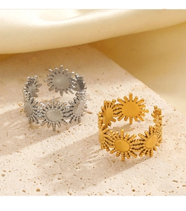 Detailed view of sunburst open rings in gold and silver finish on stone base