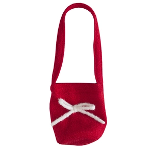 Vintage red plush bucket bag with white drawstring knot on a clean white background