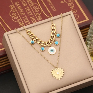 Double-layered gold stainless steel necklace featuring turquoise and evil eye pendants