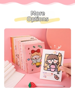 Close-up of cute pink stationery set featuring mini notebooks and a strawberry topper pen