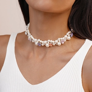 Close-up of double-layered faux pearl choker with heart-shaped colorful rhinestones