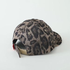 Detail of baby leopard print cap showing adjustable velcro strap and soft velvet texture