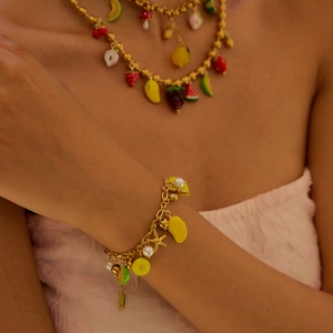 Close-up of luxury summer bracelet with colorful fruit charms and golden stainless steel links