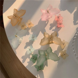 Matte butterfly hair claws in various pastel colors and two sizes for women's styling