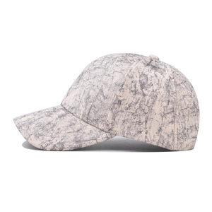 Fashionable baseball cap with grey marble texture and curved brim in side view profile