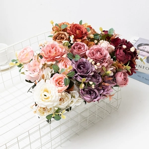 Close-up of realistic rose bouquet in vintage white wire basket for home decor