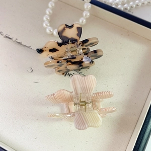 Detail of French acetate hair claws in tortoise shell and pink marble patterns