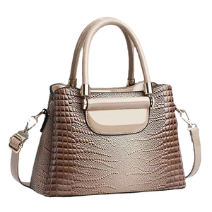Glossy crocodile embossed bucket bag in beige with top handles and shoulder strap