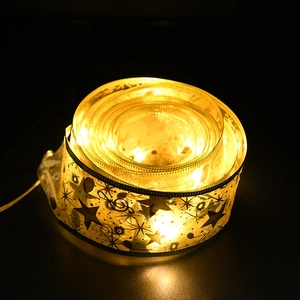 Double-layered gold-stamped ribbon LED string lights with warm yellow star and sun patterns