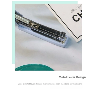 Detail of durable metal rod mechanism inside a purple Morandi desktop stapler