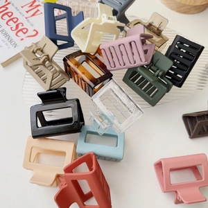 Flat lay of square matte claw clips in assorted candy colors on a white surface