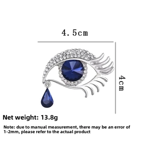 Detailed view of evil eye brooch with blue crystals and dimensions 4.5cm x 4cm