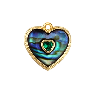 Detailed view of heart-shaped abalone shell pendant with gold plating and green gem