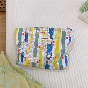 Detail of floral stripe cotton makeup bag with Simple Wish label and zipper closure