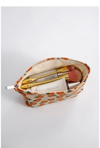 Detail of floral corduroy cosmetic bag showing spacious interior and soft fabric texture