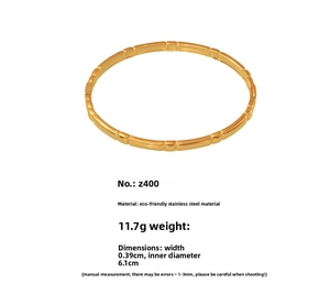 Macro detail of gold stainless steel bangle with geometric texture and product dimensions