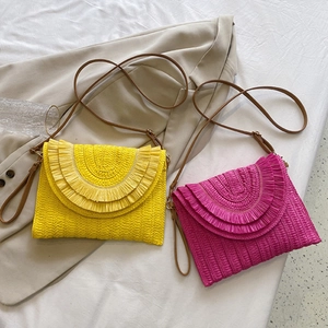 Colorful woven raffia straw envelope clutch bag with brown leather strap in yellow and rose