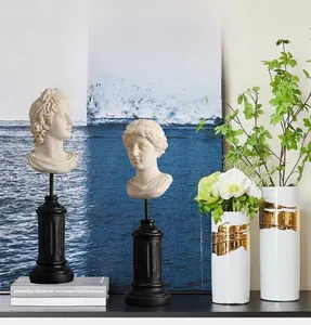 Detail of Nordic resin busts on classic black pedestals in a high-end interior setting
