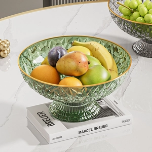 Detail of green crystal textured fruit plate with gold rim and elegant pedestal base