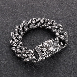Detail of heavy punk tiger head bracelet in vintage silver stainless steel with clasp