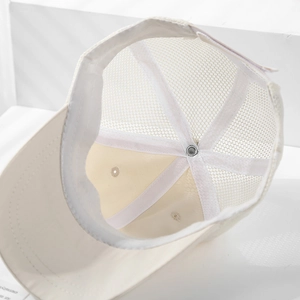 Detailed interior of mesh trucker hat showing breathable white mesh and metal top button