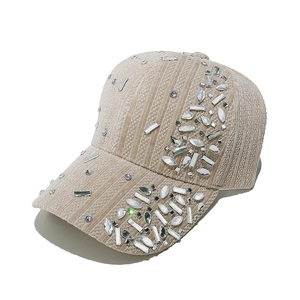 Detailed view of beige velvet baseball cap featuring intricate rhinestone embellishments