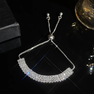 Adjustable silver rhinestone pavé tennis bracelet for women on a black glossy base