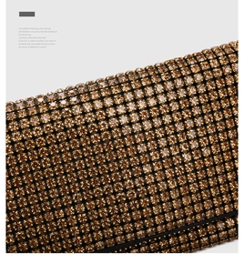 Macro view of luxury evening bag with gold rhinestones and retro wax buckle detail