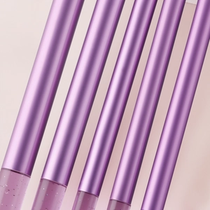 Detail of glitter crystal handle makeup brushes with metallic purple finish and liquid glitter