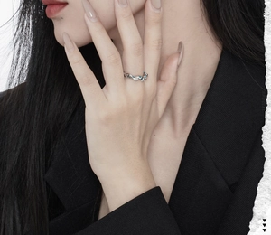 Detail of S925 sterling silver irregular ring with blue coral enamel on a model hand