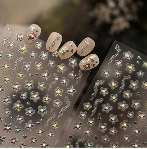 Macro shot of 3D metallic floral nail stickers with pearls and silver line details